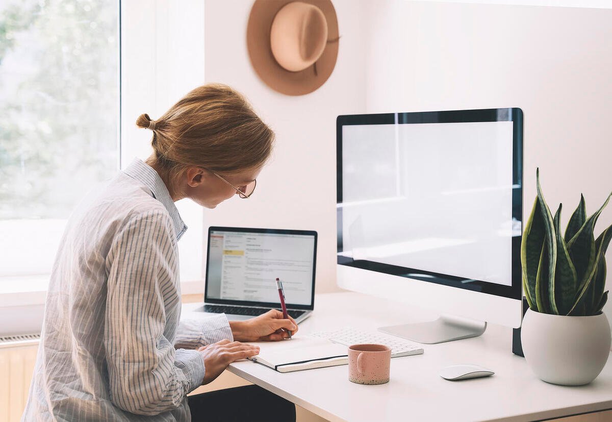 Young woman working at home office. Girl wearing in glasses works with new startup project.