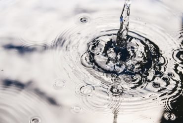 Rainwater harvesting in a large polymer tank on the terrace of a house. Ripples on the surface of water. Aquaphobia – fear of water.