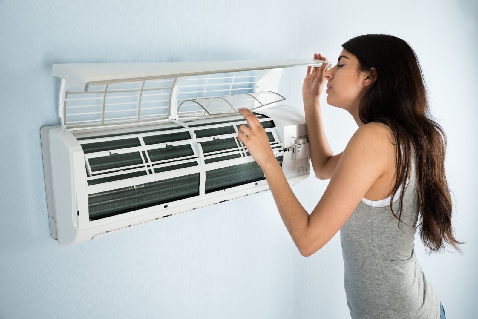 Woman Checking Air Conditioner